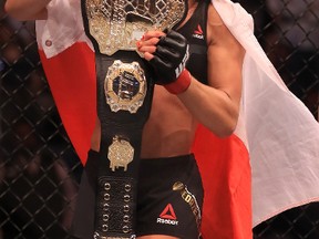 Joanna Jedrzejczyk celebrates her win in the women's strawweight title bout against Jessica Andrade during UFC 211 at American Airlines Center on May 13, 2017. (Ronald Martinez/Getty Images)