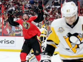 Mark Stone celebrates an Ottawa Senators goal as Pittsburgh Penguins' Sidney Crosby skates away during Game 3 at the Canadian Tire Centre on May 17, 2017. (Wayne Cuddington/Postmedia)