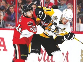 Senators forward Jean-Gabriel Pageau checks Penguins centre Evgeni Malkin in Game 3 on Wednesday. (Wayne Cuddington/Postmedia Network)