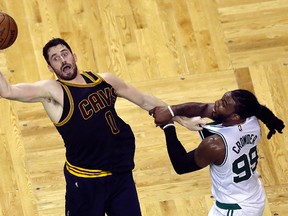 Cleveland Cavaliers forward Kevin Love, left, and Boston Celtics forward Jae Crowder grab hold of each other during the second quarter of Game 1 of the NBA basketball Eastern Conference finals, Wednesday, May 17, 2017, in Boston. (AP Photo/Charles Krupa)