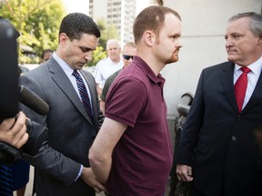 Brandon Bostian, the Amtrak engineer involved in a fatal train crash two years ago in Philadelphia, is arrested outside a police station in Philadelphia on Thursday, May 18, 2017. (AP Photo/Matt Rourke)