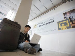 In this Saturday, April 17, 2010, file photo, a traveller from Malaysia uses his laptop computer at Schiphol Airport, Amsterdam, Netherlands. International air travellers might soon rediscover magazines, paperbacks and playing cards. Airline passengers have become hooked on their laptops and tablets to get work done or just kill time during long flights. But U.S. aviation-security officials appear determined to ban large electronic devices in the cabin of flights from Europe. (AP Photo/Peter Dejong, File)