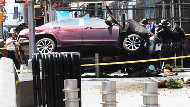 A car rests on a security barrier in New York's Times Square after driving through a crowd of pedestrians, injuring at least a dozen people, Thursday, May 18, 2017.  (AP Photo/Mary Altaffer) ORG XMIT: NYMA201