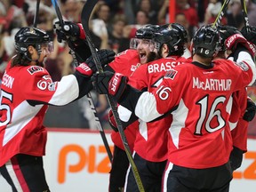 Erik Karlsson (L) joins his teammates including a happy Bobby Ryan (C) after the second goal of the game in the first period as the Ottawa Senators take on the Pittsburgh Penguins in Game 3 of the NHL Eastern Conference Finals at the Canadian Tire Centre. (Wayne Cuddington/Postmedia Network)
