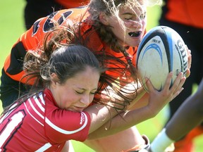 Julia Gregory of the Cowboys fights for possession with Clarke Road's Kyla Manske during their WOSSAA AAA girls rugby final. The Clarke Road Trojans defeated the Medway Cowboys 24-8 for the WOSSAA crown in AAA girls rugby at Medway on Thursday May 18, 2017.  Mike Hensen/The London Free Press/Postmedia Network