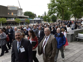 People mill about after the evacuation of the Shaw Centre, Rideau Centre mall and Westin hotel after a large sinkhole formed on Rideau Street on Wednesday.