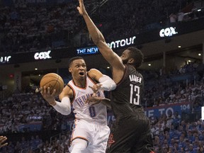 Russell Westbrook of the Oklahoma City Thunder drives around James Harden of the Houston Rockets during an NBA game on April 21, 2017 in Oklahoma City. (J Pat Carter/Getty Images)