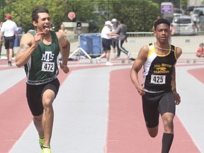 Mother Teresa's Adam Nalywaiko, left, looks over at Adrian Livingston of Mgsr. Bruyere during the senior boys 100-metre final at the WOSSAA track and field championships Thursday at TD Waterhouse Stadium. Nalywaiko finished in the top six to advance to OFSAA West regionals next week. WOSSAA continues Friday. (Cory Smith/Postmedia News)