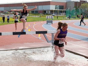Athletes compete in the open girls 1,500 metre steeplechase event at the local high school track and field championships at the track at Laurentian University in Sudbury, Ont. on Thursday May 18, 2017. John Lappa/Sudbury Star/Postmedia Network