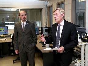 Kingston Mayor Bryan Paterson watches Utilities Kingston President and CEO Jim Keech at the King Street Water Filtration Plant. (Ian MacAlpine/The Whig-Standard)