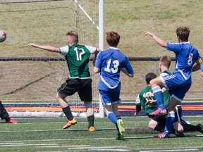 Ernestown Eagles keeper Will Huyck makes a save off a shot from Kingston Blues' Graeme Workman (8) in the first half of the Kingston Area Secondary Schools Athletic Association senior boys soccer final Thursday at Richardson Stadium. KC wound up winning the game, 1-0. (Tim Gordanier/The Whig-Standard)
