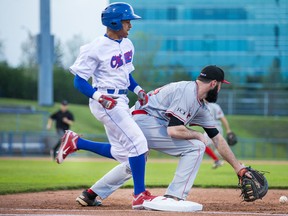 Ottawa Champions’ Adron Chambers beats out the throw to first base as Trois Riviere’s Zach Mathieu gets the glove down during last night’s season-opener. (WAYNE CUDDINGTON/Postmedia Network)