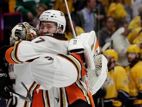 Anaheim Ducks centre Andrew Cogliano (7) celebrates with goalie John Gibson (36) after defeating the Nashville Predators in overtime of Game 4 of the Western Conference final in the NHL hockey Stanley Cup playoffs Thursday, May 18, 2017, in Nashville, Tenn. The Ducks won 3-2. (AP Photo/Mark Humphrey)