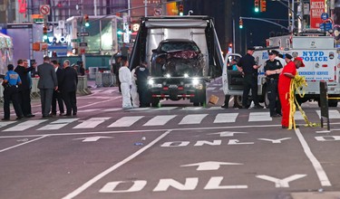 The car driven by a man who steered his car onto a busy Times Square sidewalk is removed by police and investigators from the crime scene area, Thursday, May 18, 2017, in New York. A 26 year-old U.S. Navy veteran steered his car onto a sidewalk running through the heart of Times Square and mowed down pedestrians for three blocks Thursday. The driver was subdued by police and bystanders at the site. (AP Photo/Kathy Willens)