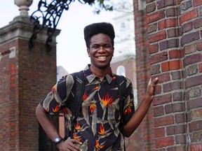 Obasi Shaw poses outside the gates of Harvard Yard in Cambridge, Mass., Thursday, May 18, 2017. Shaw, an English major who graduates from Harvard next week, is the university's first student to submit his final thesis in the form of a rap album. The record, called “Liminal Minds,” has earned the equivalent of an A- grade, good enough to ensure that Shaw will graduate with honors at the university’s commencement next week. (AP Photo/Charles Krupa)