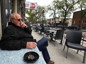 Mario smokes a cigarette on a patio at Bar Italia on Corydon Avenue in Winnipeg on Wed., May 17, 2017. Kevin King/Winnipeg Sun