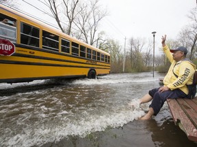 Bus driver Mario Banaag waves to another bus driver at the side of the road on Centre Island on Tuesday May 16, 2017. (Stan Behal/Toronto Sun)