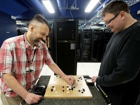 University of Alberta computing science professors Ryan Hayward (left) and Martin Muller play a game of Go in a computer server room at the University of Alberta, in Edmonton Thursday May 18, 2017. DAVID BLOOM / POSTMEDIA