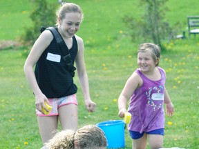 More than 90 students with special needs from the Avon Maitland District School Board, including Katie Bernard (right, in purple top) and Emily Bauer, were paired up with Mitchell District High School (MDHS) students’ Taya Cornish (back, left) and Emma French for a day of fun in the sun on Wednesday, May 17.  ANDY BADER/MITCHELL ADVOCATE