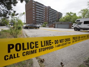 Police tape on Friday, May 19, 2017 marks the scene where a woman was found fatally injured the night before in a parking lot near Scarlett Road and Dundas Street West in Toronto. (Stan Behal/Toronto Sun)