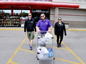 Ben Fraraccio, owner of Grocery Guy (centre), and employees Beau Sexton (left) and Brittney Yeomans are expanding the London-based small business to nearby Kitchener-Waterloo. CHRIS MONTANINI\LONDONER\POSTMEDIA NETWORK