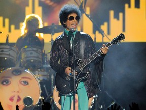 In this May 19, 2013, file photo, Prince performs at the Billboard Music Awards at the MGM Grand Garden Arena in Las Vegas. In a ruling made public Friday, May 19, 2017, a Minnesota judge ruled that Prince's six siblings are the heirs to his estate, more than a year after the pop superstar died of a drug overdose. (Photo by Chris Pizzello/Invision/AP, File)