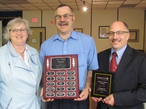 The 2017 Community Living Sarnia Living Hero Award was given Friday May 19, 2017 to the Lowe's store in Sarnia. From left, Margaret Butt, human relations with Lowe's, Brian Park with Community Living and Lino Tesolin, manager of the Lowe's store in Sarnia, are shown with the award following the 15th annual Mayor's Luncheon held at the Royal Canadian Legion hall in Sarnia. (Paul Morden/Sarnia Observer)