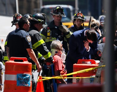 Emergency personnel treat a victim after a car ploughed through a crowd of pedestrians during lunchtime at New York's Times Square, Thursday, May 18, 2017. Police do not suspect a link to terrorism and the driver was taken into custody to be tested for alcohol. (AP Photo/Seth Wenig)