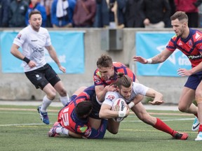 Liam Kay, being tackled during the Wolfpack's incident-filled romp over Oxford  earlier in May, sat out a one-game suspension. (Chris Young, The Canadian Press)