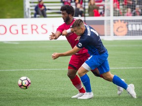 Ottawa Fury FC’s Michael Salazar battles for the ball with Pittsburgh Riverhounds’ Taylor Washington during last week’s game. (ASHLEY FRASER/Postmedia Network)