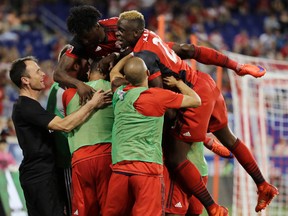 Toronto FC celebrates Benoit Cheyrou's game-tying goal on Friday against the New York Red Bulls. (AP)