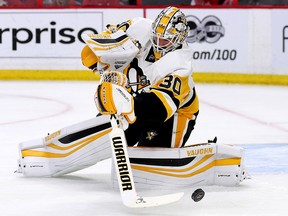 Matt Murray clears the puck during Pittsburgh’s 3-2 win over Ottawa last night. Murray was rarely tested in his first start in weeks. Wayne Cuddington/Postmedia Network