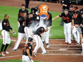 Baltimore Orioles Welington Castillo, centre, celebrates with teammates after hitting the game winning home run in the 10th inning against the Toronto Blue Jays at Oriole Park at Camden Yards on May 19, 2017 in Baltimore, Maryland. Baltimore won the game 5-3. (Photo by Greg Fiume/Getty Images)