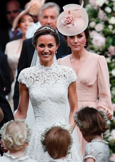 Britain's Catherine, Duchess of Cambridge, (R) follows her sister Pippa Middleton following the wedding of Middleton to James Matthews at St. Mark's Church in Englefield, west of London, on May 20, 2017. (KIRSTY WIGGLESWORTH/AFP/Getty Images)