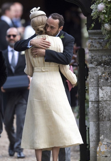 Brother of the bride, James Middleton, embraces girlfriend Donna Air as they arrive for the wedding ceremony of Pippa Middleton to James Matthews at St. Mark's Church as the bridesmaids and pageboys walk ahead on May 20, 2017 in Englefield Green, England.  (Arthur Edwards - WPA Pool/Getty Images)