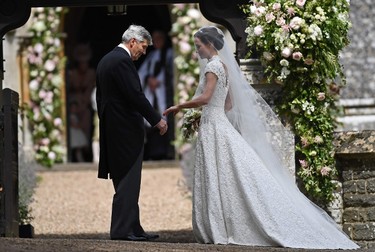 Michael Middleton (L), stands with his daughter Pippa Middleton, as they arrive for her wedding to James Matthews at St. Mark's Church in Englefield, west of London, on May 20, 2017. (JUSTIN TALLIS/AFP/Getty Images)