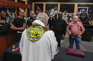 Rev. Jerry Hogan, of the U.S. Conference of Catholic Bishops' Circus and Traveling Shows Ministry, leads a baptism service for the son of a member of the crew before a Ringling Bros. circus show at the Dunkin Donuts Center, Thursday, May 4, 2017, in Providence, R.I. Hogan's vestments were made by the costume department from old elephant blankets. (AP Photo/Julie Jacobson)