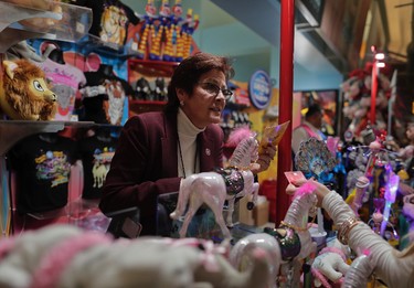 Concessions manager Jeannie Hamilton helps a customer at one of the many memorabilia booths after a Ringling Bros. show, Saturday, May 6, 2017, in Providence, R.I.  (AP Photo/Julie Jacobson)