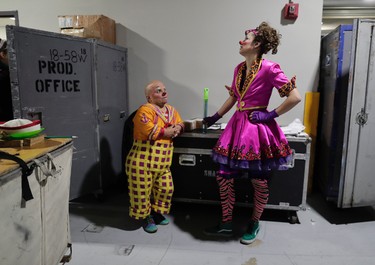 Clowns Gabor Hrisafis, left, and Beth Walters talk in a hallway of the Dunkin Donuts center before a performance, Thursday, May 4, 2017, in Providence, R.I. (AP Photo/Julie Jacobson)