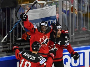 Ryan O'Reilly (right) reacts after scoring Canada's third goal against Russia with teammates Wayne Simmonds (centre) and Mike Matheson during the world championship semifinal at the LANXESS Arena in Cologne, Germany on Saturday, May 20, 2017. (Martin Meissner/AP Photo)