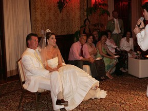 The late actor Alan Thicke and model Tanya Callau (L) listen as Thicke's son Robin sings to them at their wedding reception at The One&Only Pamilla Resort in Cabo San Lucas, Mexico in this May 7, 2005 file photo. (Vince Bucci/Getty Images)