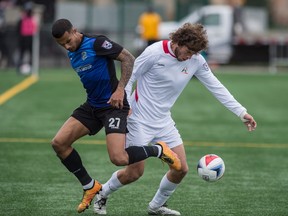 Netan Sansara of FC Edmonton, and Tommy Heinemann of the San Francisco Deltas battle for possession at Clark Field in Edmonton on May 14, 2017.