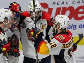 Erie Otters' TJ Fergus, Troy Timpano, Dylan Strome and Alex DeBrincat (left to right) celebrate their victory over the Seattle Thunderbirds during Memorial Cup round robin action in Windsor, Ont. on Saturday, May 20, 2017. (Dave Chidley/The Canadian Press)