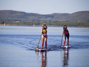 There was plenty of sunshine in the national capital area on Saturday, bringing paddlers out to the Ottawa River at Constance Bay. Laura Finlay, left, and Mel Berry were among those on the water.