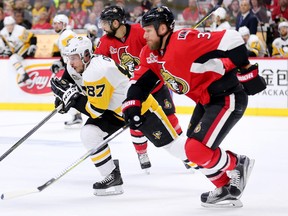 Penguins captain Sidney Crosby (left) and Senators defenceman Marc Methot (right) chase the puck during the second period in Game 4 of the NHL's Eastern Conference final at the Canadian Tire Centre in Ottawa on Friday, May 19, 2017. (Wayne Cuddington/Postmedia)