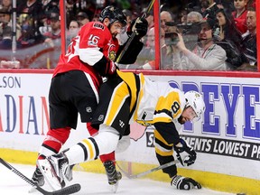 Senators forward Clarke MacArthur (left) checks Penguins defenceman Brian Dumoulin into the boards in the first period in Game 4 of the NHL's Eastern Conference final at the Canadian Tire Centre in Ottawa on Friday, May 19, 2017. (Wayne Cuddington/Postmedia)