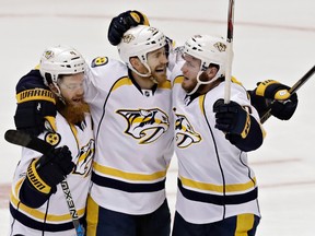 Predators centre Colin Wilson (centre) celebrates with teammates Ryan Ellis (left) and Colton Sissons after Wilson scored against the Ducks during the second period of Game 5 in the NHL's Western Conference final in Anaheim, Calif., on Saturday, May 20, 2017. (Chris Carlson/AP Photo)