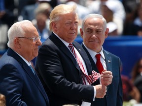 From left, Israeli President Reuven Rivlin, US President Donald Trump, and Israeli Prime Minister Benjamin Netanyahu listen during an arrival ceremony in honor of Trump, at Ben Gurion International Airport, Monday, May 22, 2017, in Tel Aviv. Trump opened his first visit to Israel Monday, a two-day stop aimed at testing the waters for jumpstarting the dormant Middle East peace process. (AP Photo/Evan Vucci)