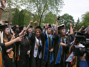 Notre Dame students walk out of the commencement ceremony in opposition opposed to the Trump administration's policies as Vice President Mike Pence is introduced at Notre Dame Stadium on Sunday, May 21, 2017, in South Bend, Ind. (Santiago Flores/South Bend Tribune via AP)