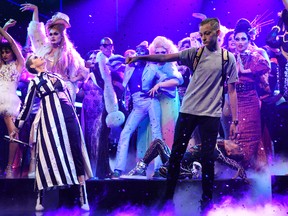 In this Saturday, May 20, 2017, photo provided by NBC, Russell Horning dances on stage alongside Katy Perry during her performance of "Swish Swish" on "Saturday Night Live" in New York. Horning, an Instagram dancing sensation has gone from online to on-air after Perry invited him to show off his moves during her “Saturday Night Live” performance. (Will Heath/NBC via AP)